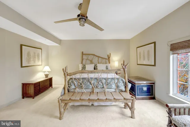 a bedroom with a bed mirror and window