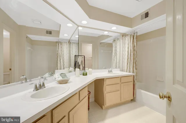 a bathroom with a double vanity sink mirror and double