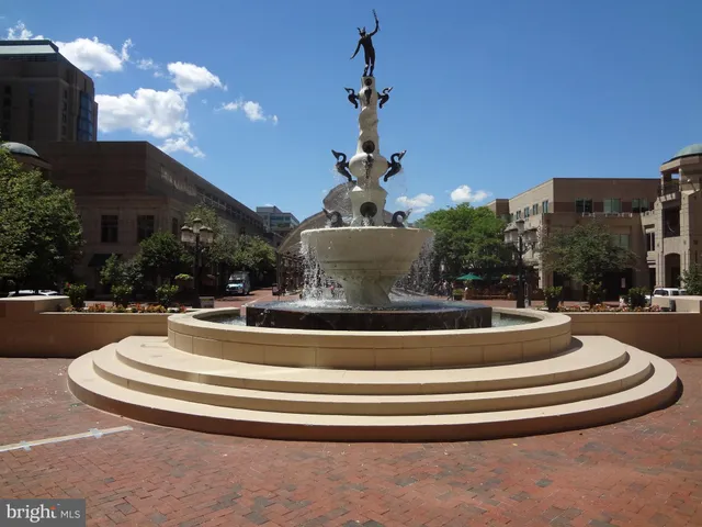 a view of a building with fountain in front of it