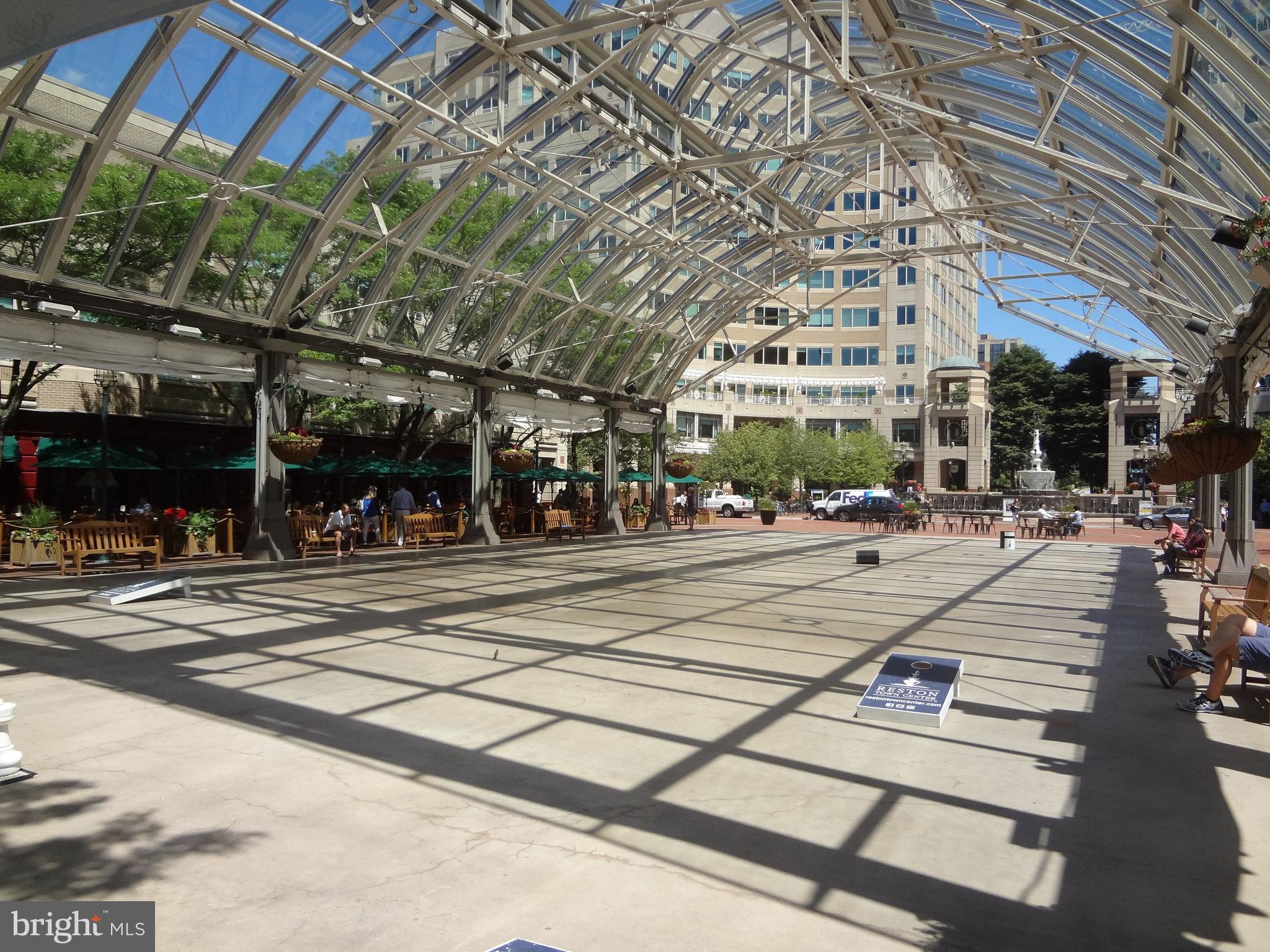 1334 Garden Wall Circle, Unit E Reston, VA 20194 - Photo 49 of 51 Sunlit urban plaza with glass canopy.