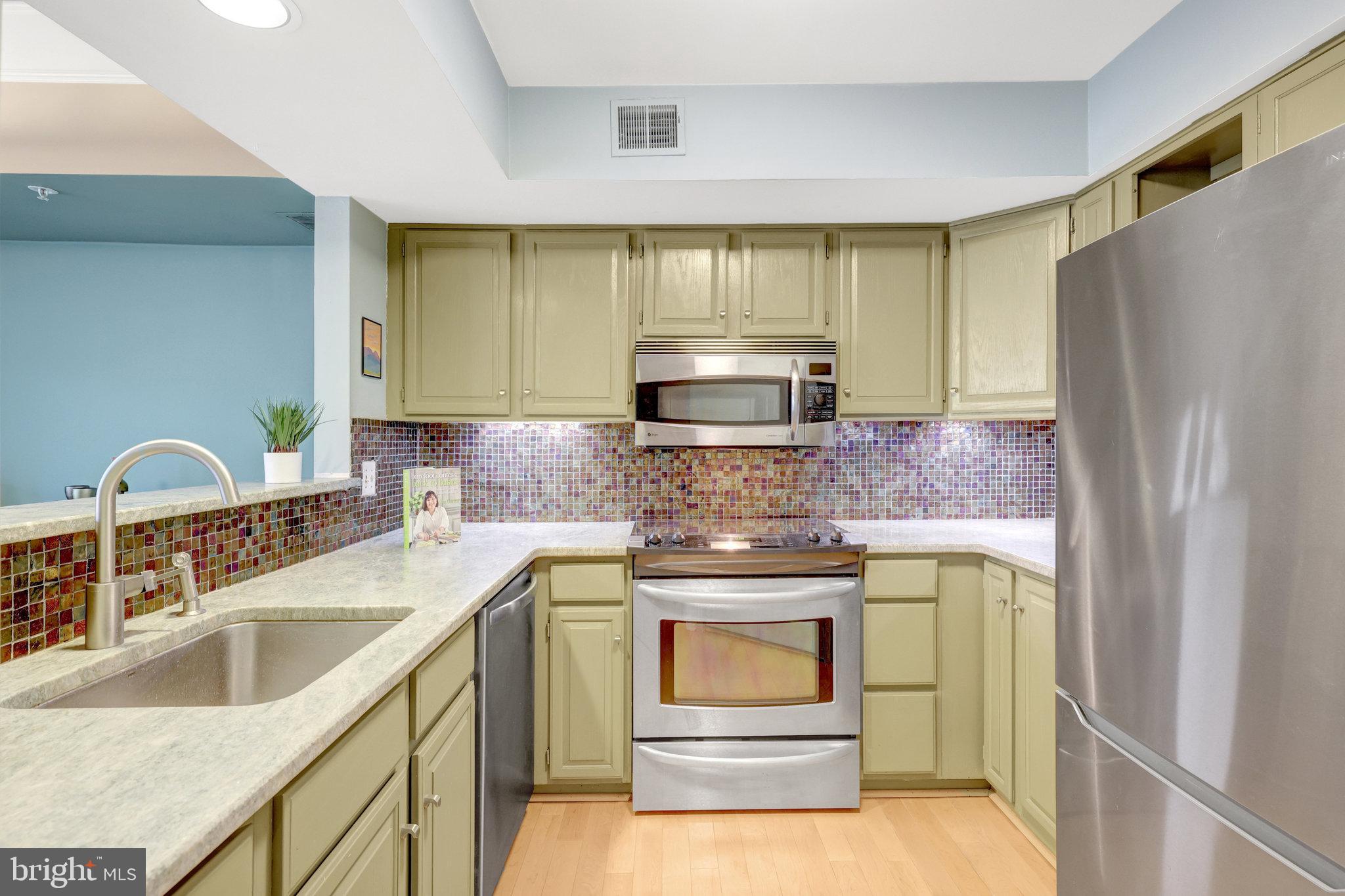1334 Garden Wall Circle, Unit E Reston, VA 20194 - Photo 5 of 23 a kitchen with stainless steel appliances granite countertop a refrigerator sink and stove