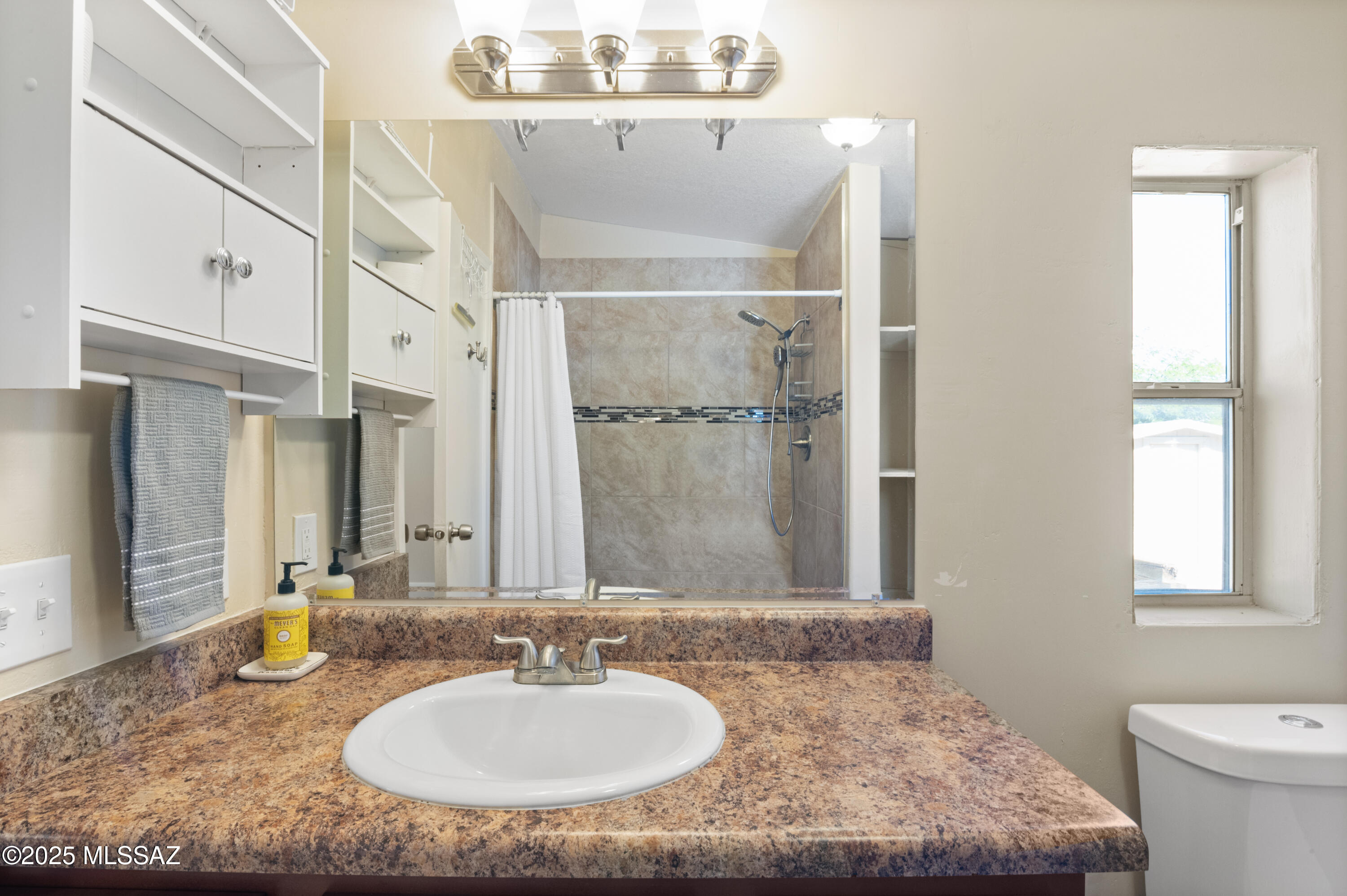 6205 East Rough Rock Drive Tucson, AZ 85756 - Photo 12 of 30 a bathroom with a granite countertop sink a mirror and a toilet