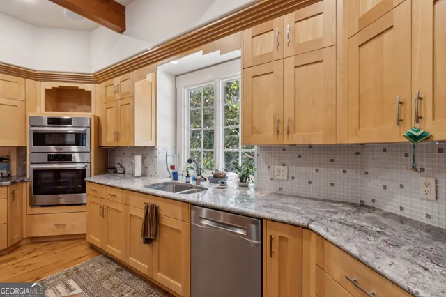 a spacious bedroom with a bed and a chandelier