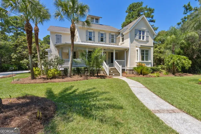 a front view of a house with a yard table and chairs
