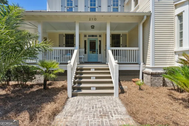 a view of a balcony with chairs and wooden floor