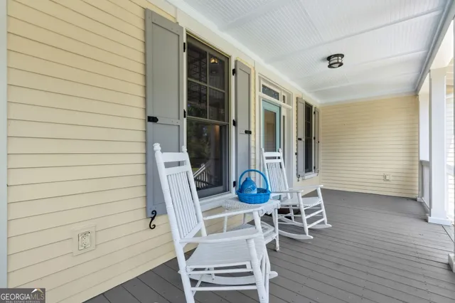 a view of a livingroom with wooden floor and a flat screen tv