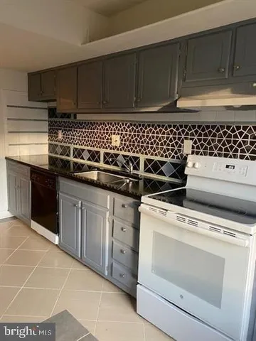 a view of a kitchen with dishwasher and cabinets