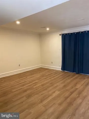 an empty room with wooden floor