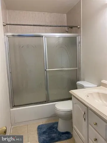 a white toilet sitting next to a bathroom sink