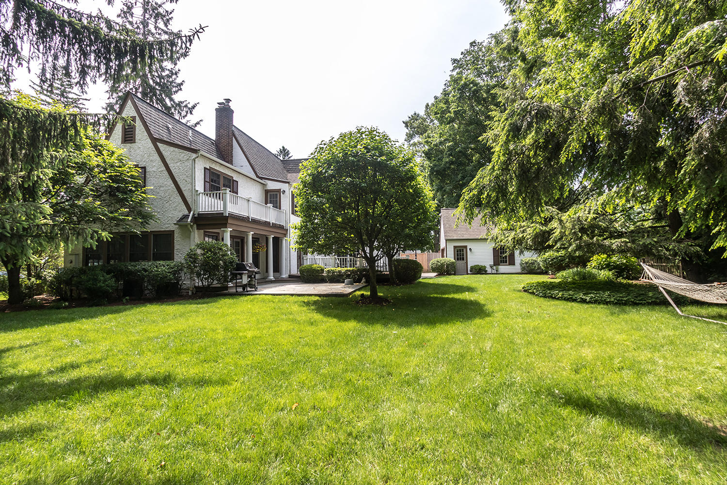 8 Abbey Road Darien, CT 06820 - Photo 37 of 39 a view of a house with pool and a garden