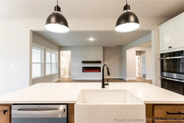 a kitchen with a stove a sink and a refrigerator