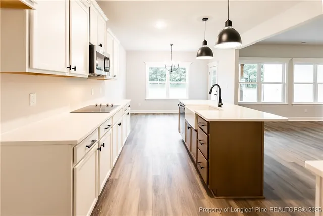 a kitchen with a sink a window and stainless steel appliances