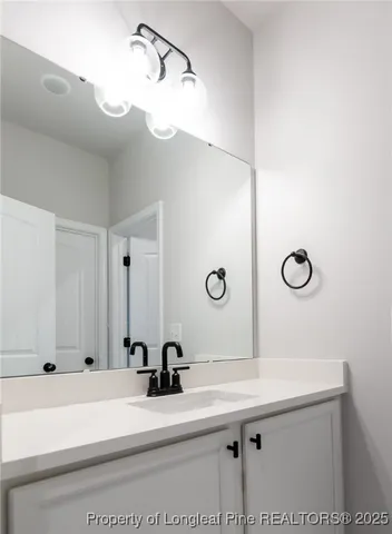 a bathroom with a sink a vanity and mirror