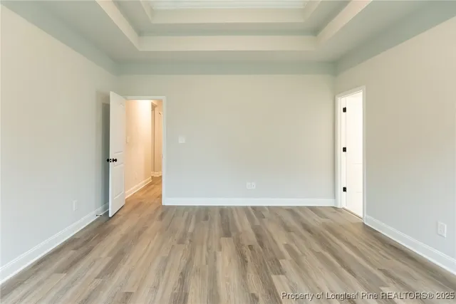 a view of a room with wooden floor