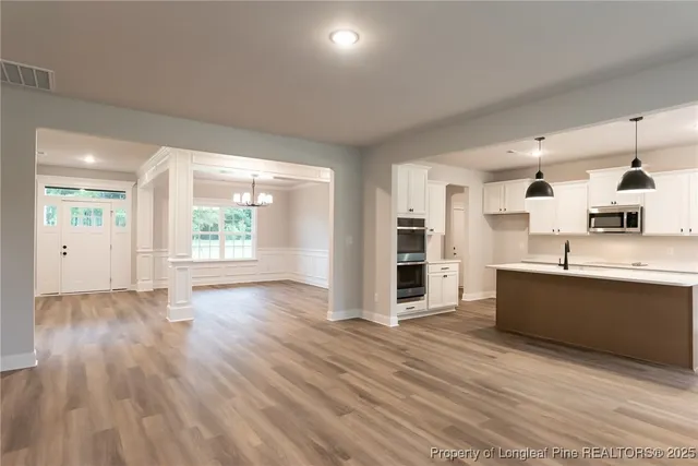 a large space with a large window and wooden floor