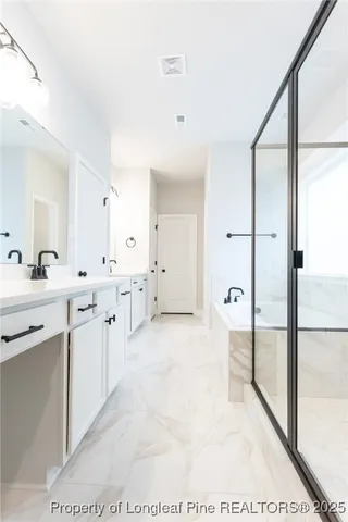 a large white kitchen with a sink and a large mirror
