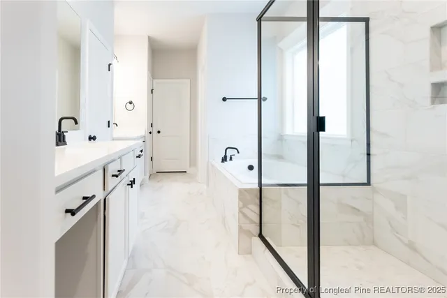 a bathroom with a tub sink and mirror