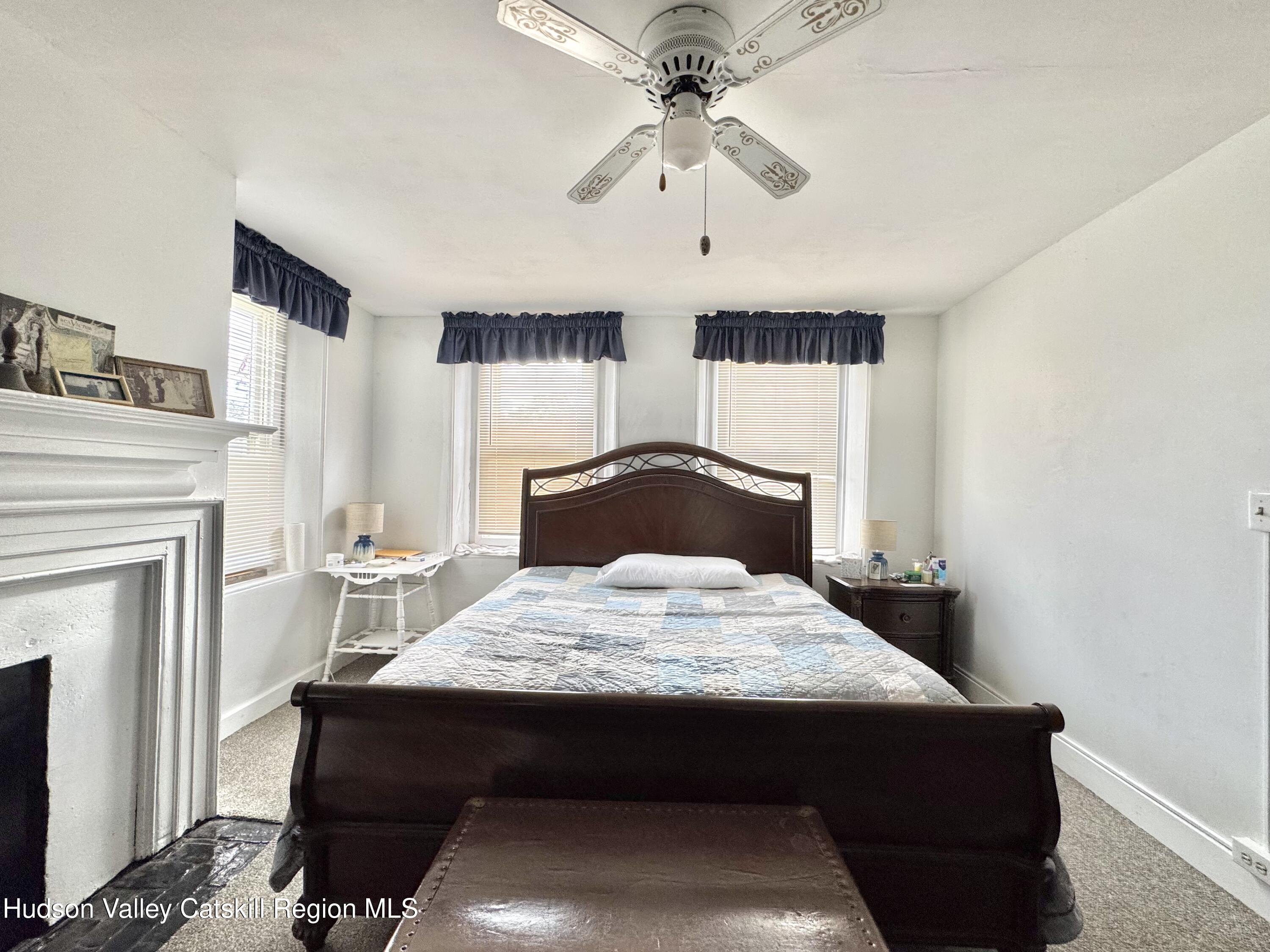1114 Main Street Catskill, NY 12451 - Photo 18 of 40 a bedroom with a bed and a fireplace