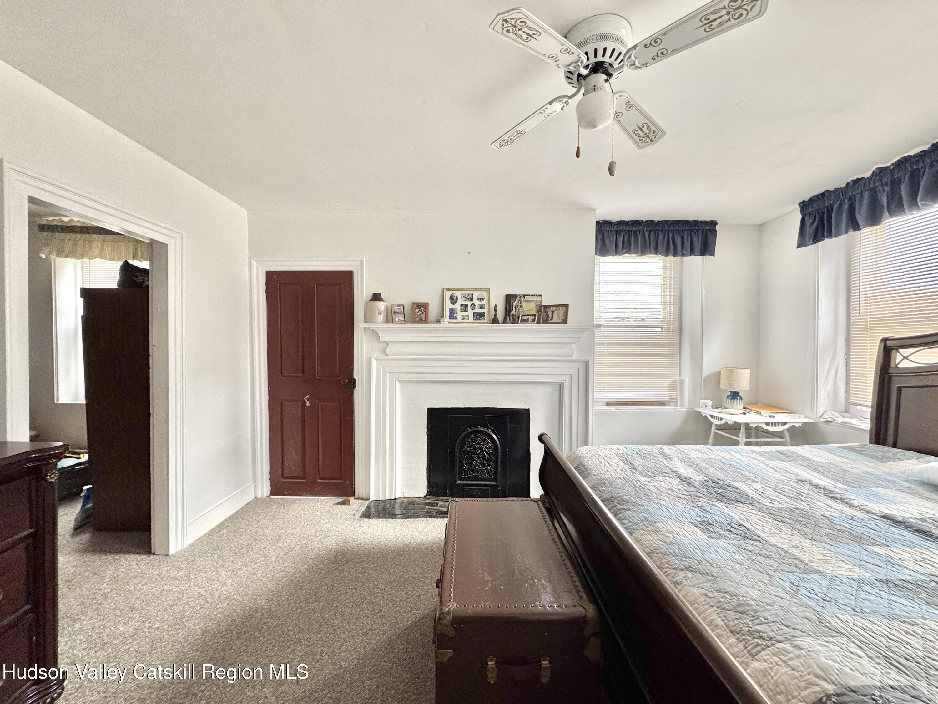 1114 Main Street Catskill, NY 12451 - Photo 19 of 40 a bedroom with a bed and a fireplace