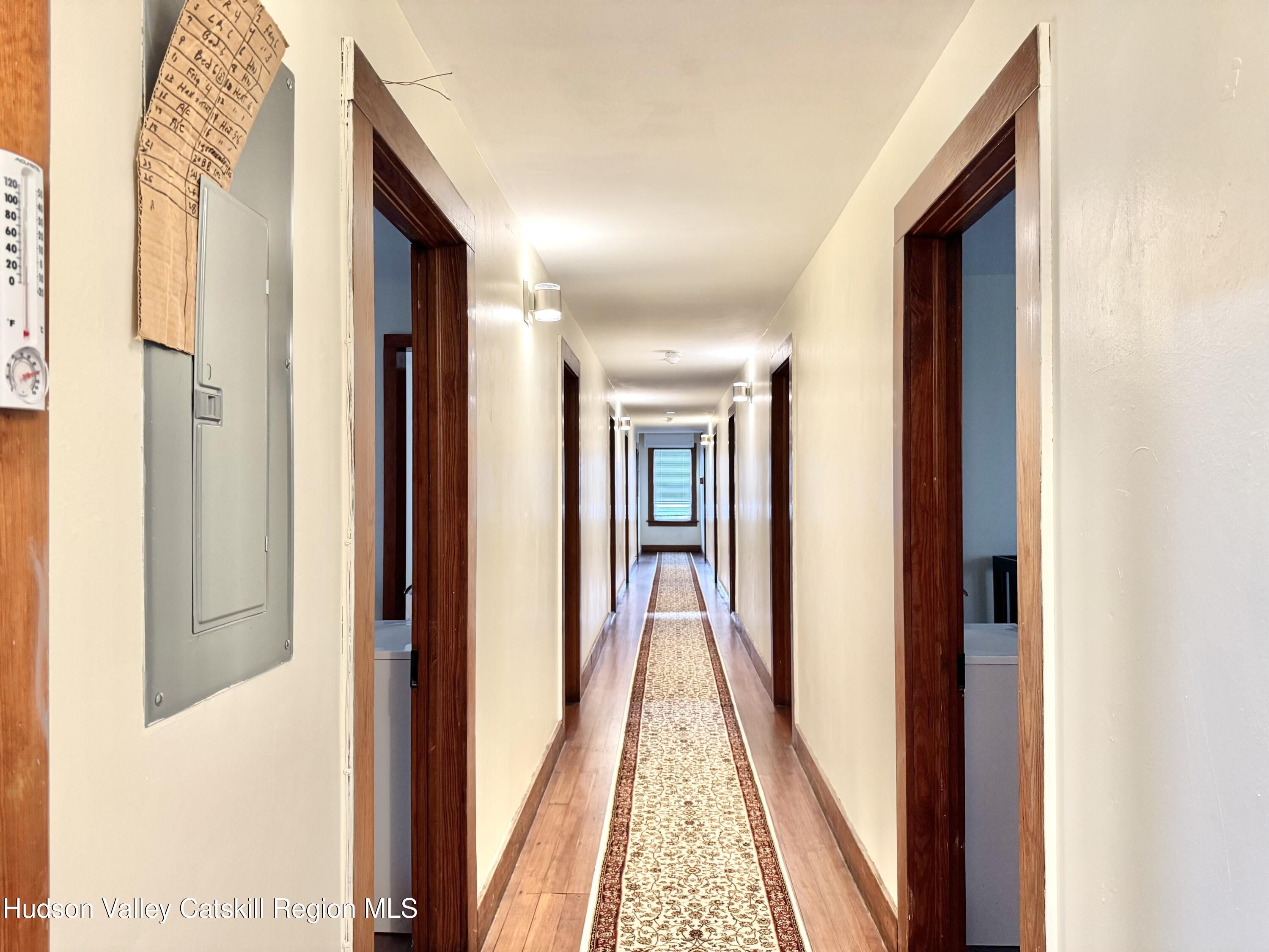 1114 Main Street Catskill, NY 12451 - Photo 23 of 40 a view of a hallway with wooden floor and stairs
