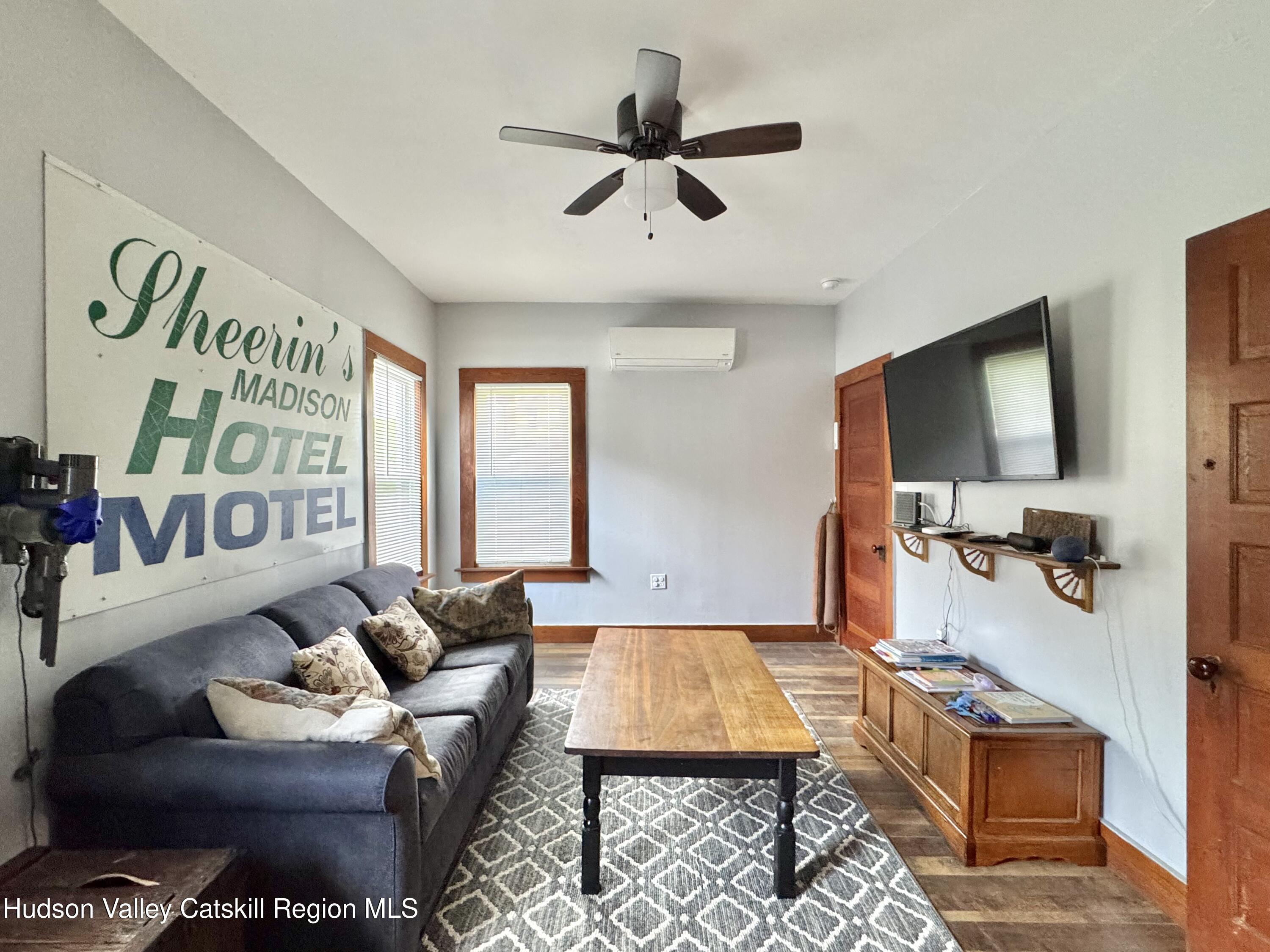 1114 Main Street Catskill, NY 12451 - Photo 24 of 40 a living room with furniture and a flat screen tv