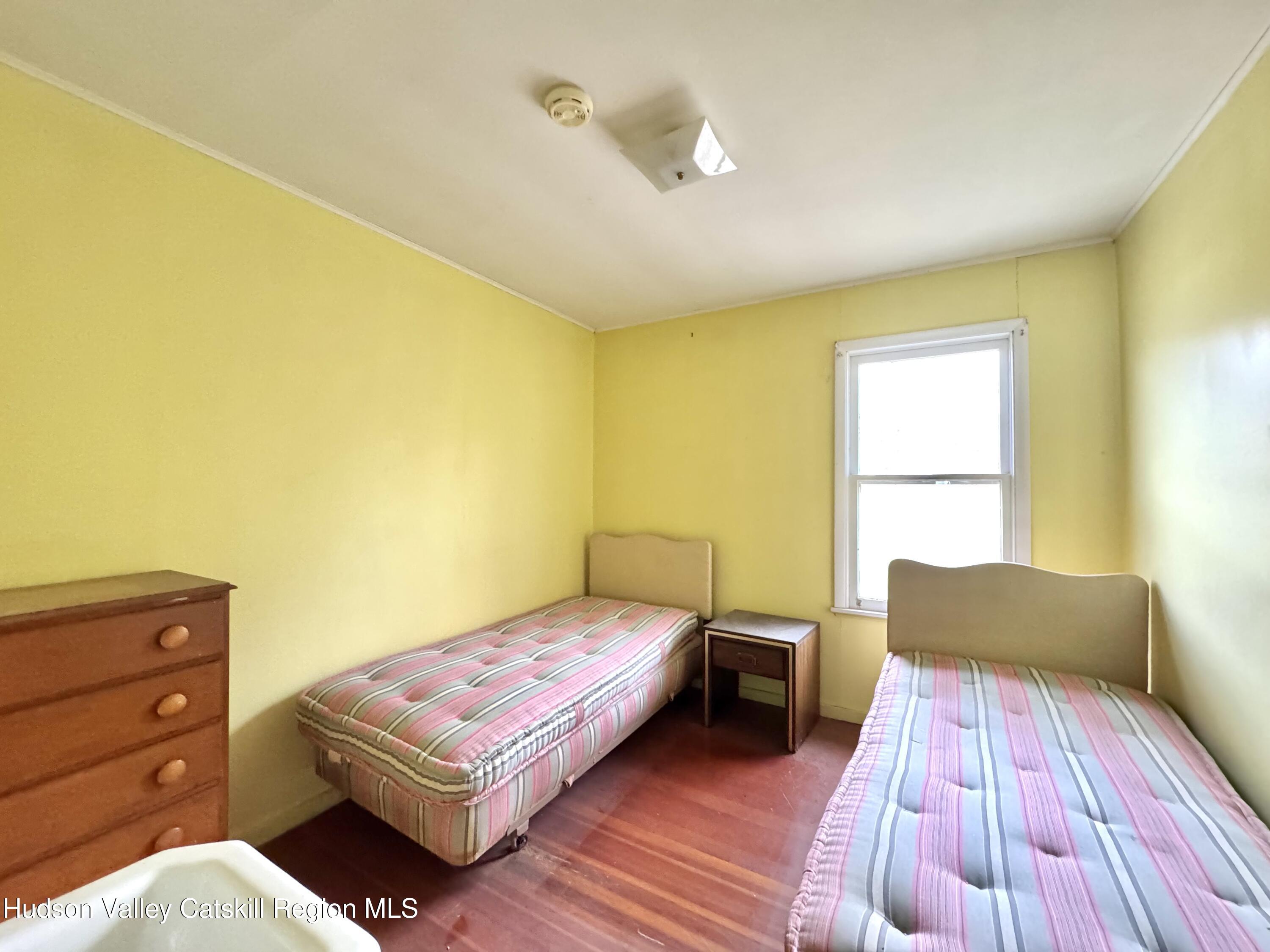 1114 Main Street Catskill, NY 12451 - Photo 25 of 40 a bedroom with a bed and wooden floor
