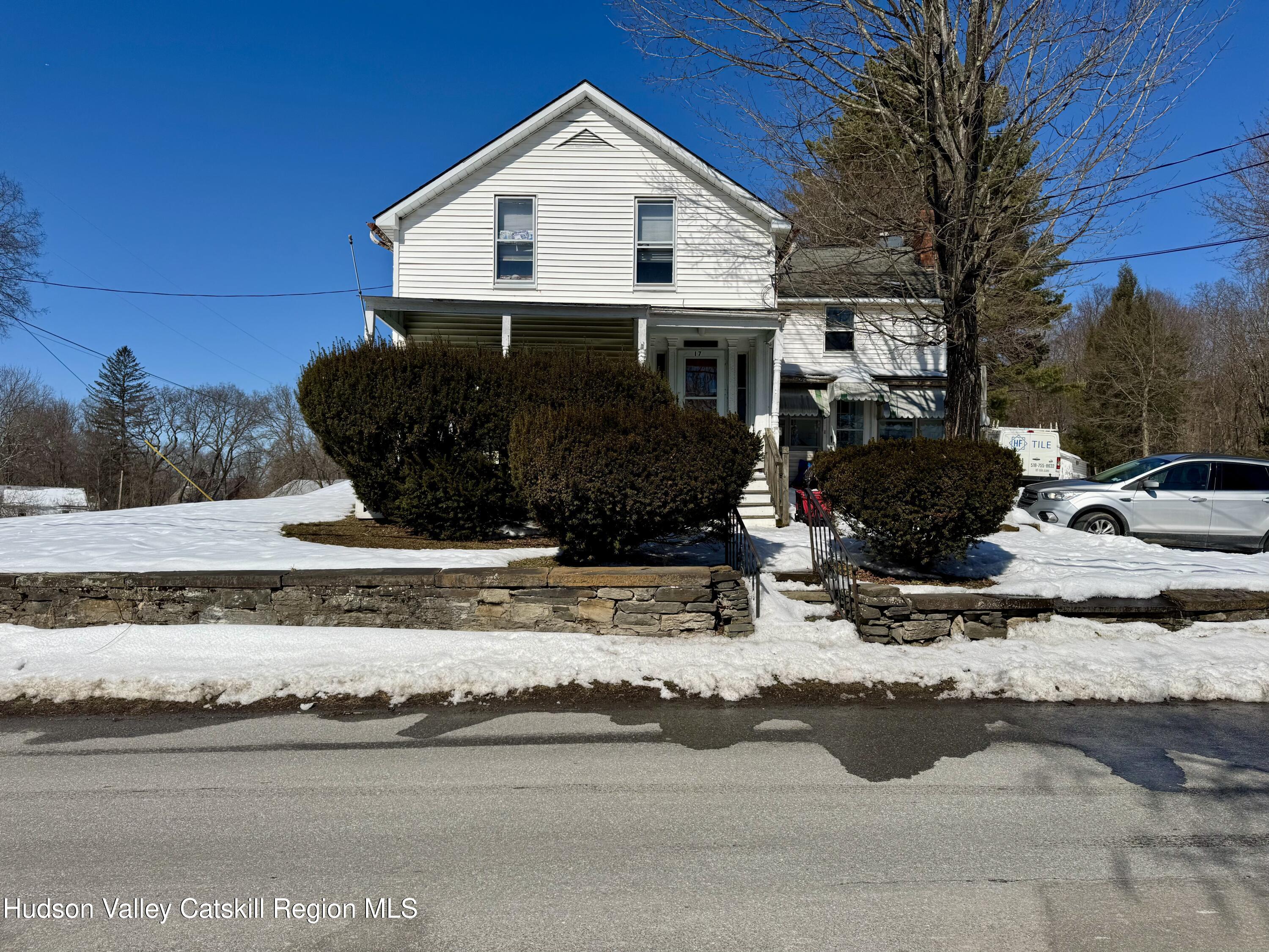 1114 Main Street Catskill, NY 12451 - Photo 5 of 40 a view of a house with a yard covered in snow