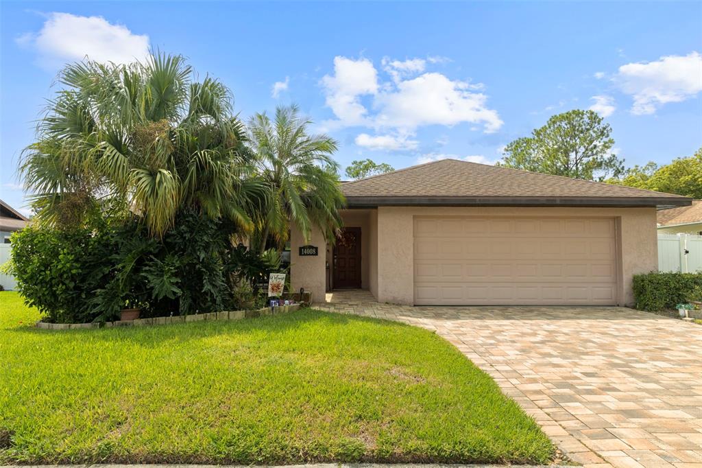 a front view of house with yard and trees