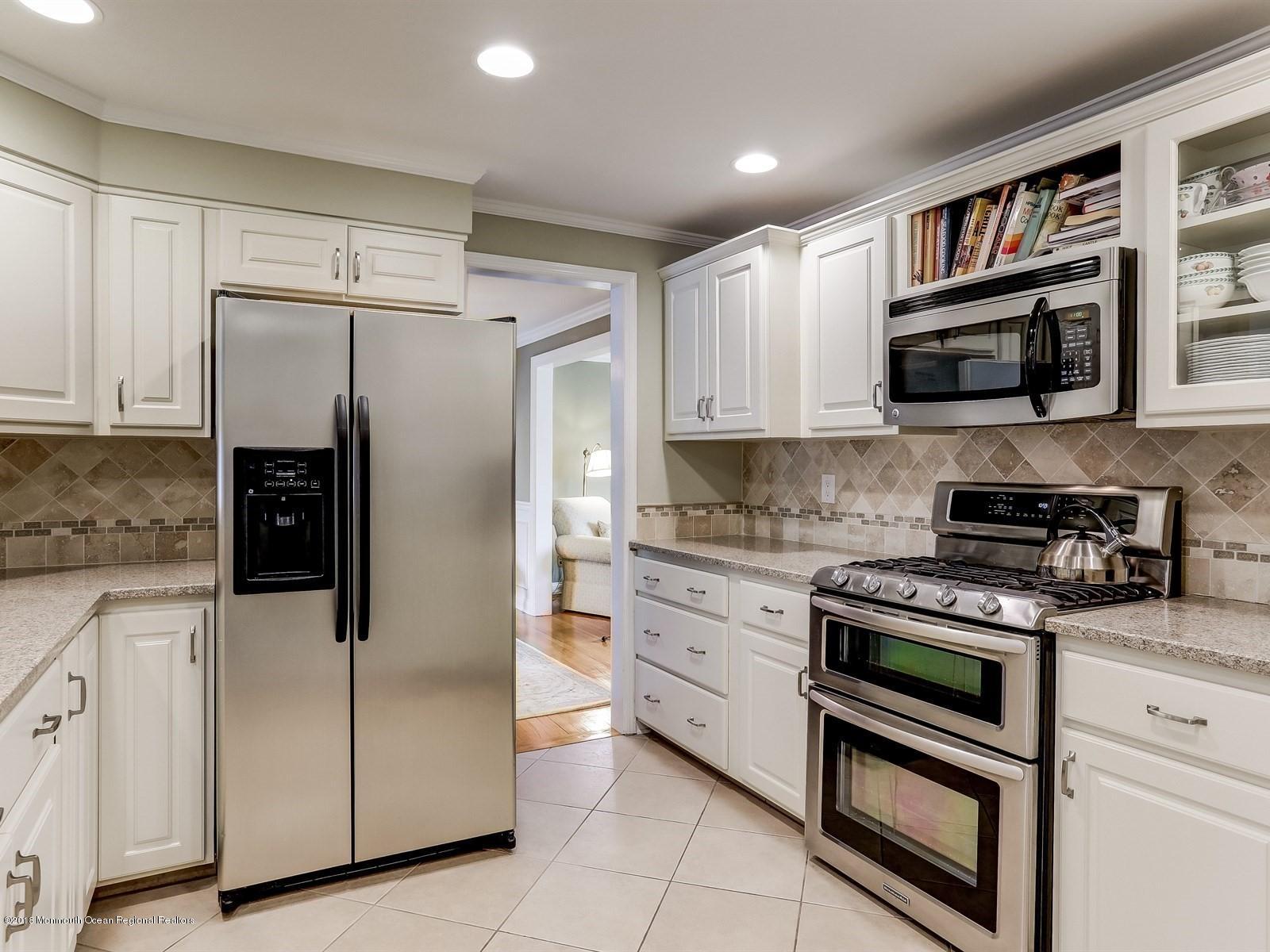 16 Rivers Edge Drive Little Silver, NJ 07739 - Photo 7 of 33 a kitchen with stainless steel appliances granite countertop a refrigerator and a stove top oven