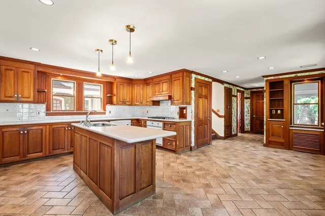 a kitchen with stainless steel appliances granite countertop a stove and a refrigerator