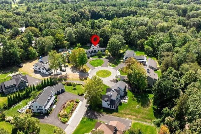 an aerial view of residential house with yard and outdoor seating