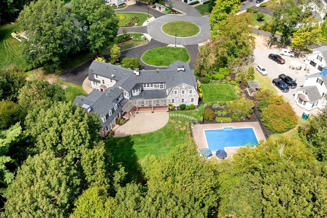 an aerial view of a house with yard swimming pool and outdoor seating