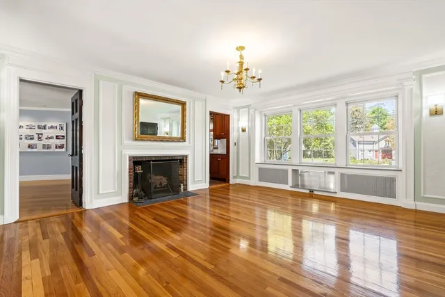 a view of an empty room with a fireplace and a window