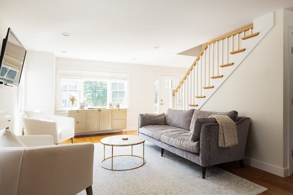 3 Garrison Road Wellesley, MA 02482 - Photo 11 of 36 a living room with furniture a flat screen tv and a large window