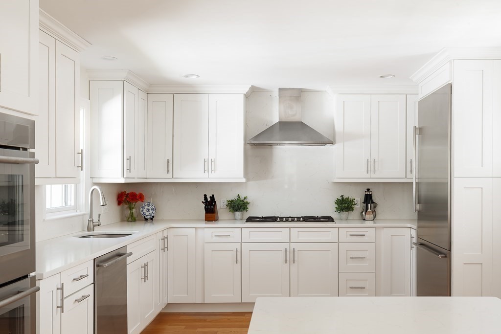 3 Garrison Road Wellesley, MA 02482 - Photo 2 of 36 a kitchen with white cabinets and white appliances
