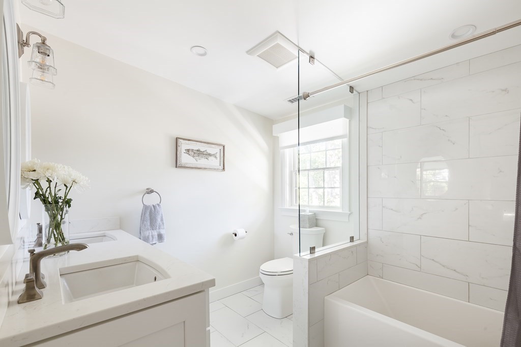 3 Garrison Road Wellesley, MA 02482 - Photo 21 of 36 a bathroom with a sink a toilet a tub and shower