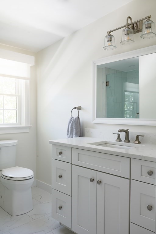 3 Garrison Road Wellesley, MA 02482 - Photo 28 of 36 a bathroom with a toilet sink and mirror