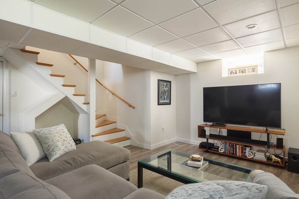 3 Garrison Road Wellesley, MA 02482 - Photo 30 of 36 a living room with furniture and a flat screen tv