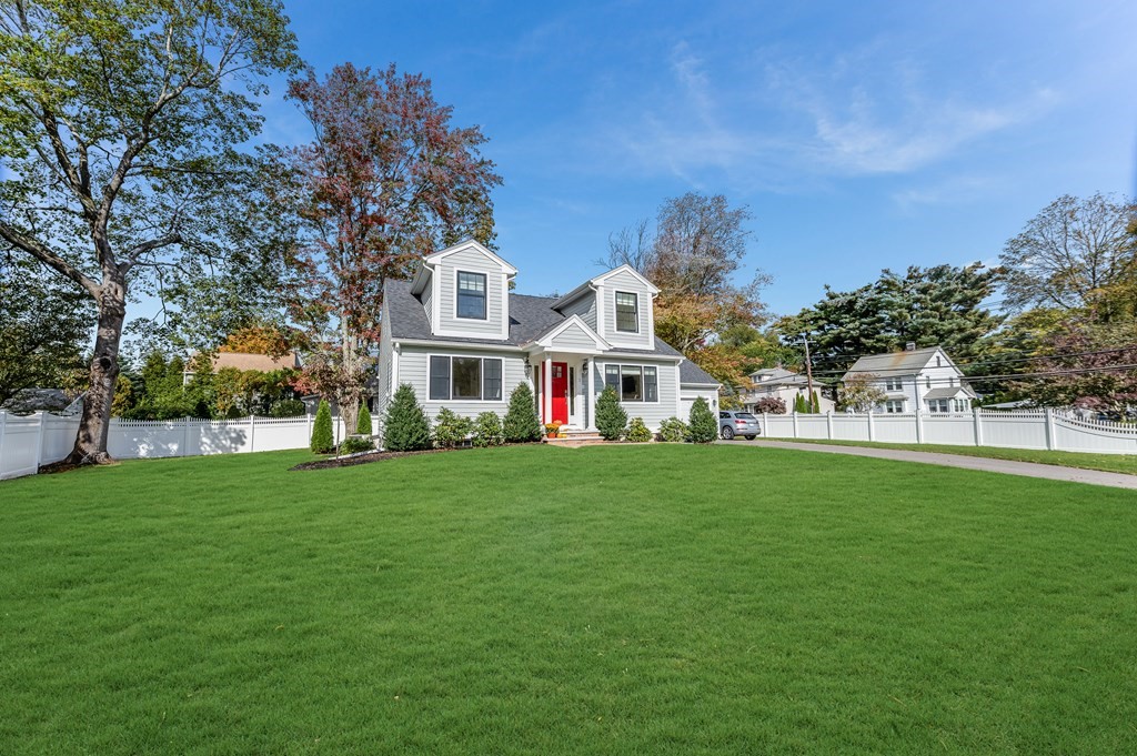 3 Garrison Road Wellesley, MA 02482 - Photo 34 of 36 a view of a white house in front of a big yard with plants and large trees