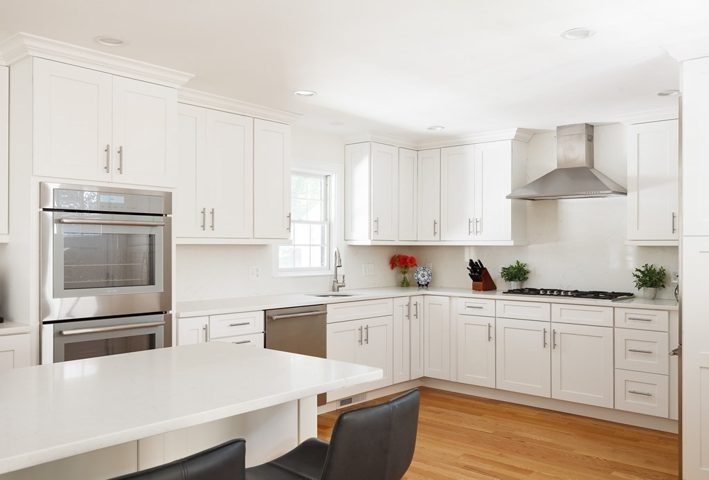 3 Garrison Road Wellesley, MA 02482 - Photo 5 of 36 a kitchen with granite countertop white cabinets and stainless steel appliances