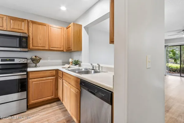a kitchen with a sink stove and microwave