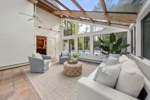 a living room with furniture and a chandelier