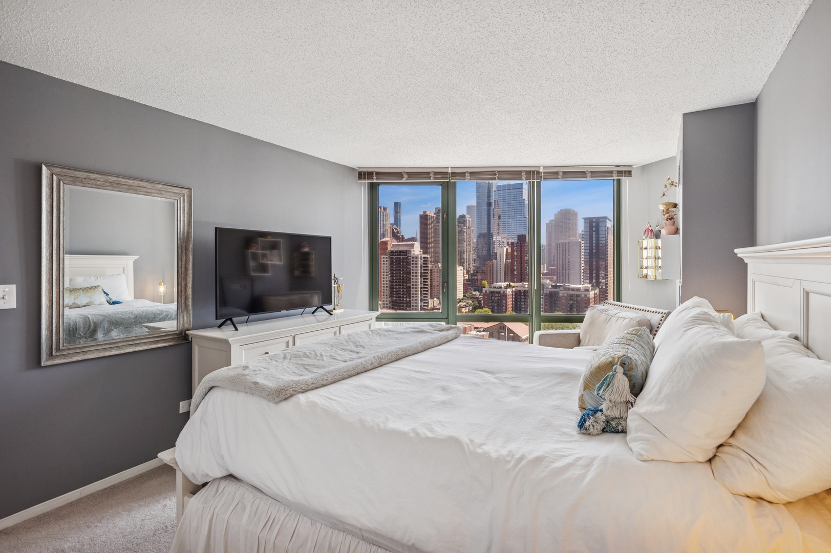 111 West Maple Street, Unit 1704 Chicago, IL 60610 - Photo 11 of 24 a bedroom with a bed and a flat screen tv