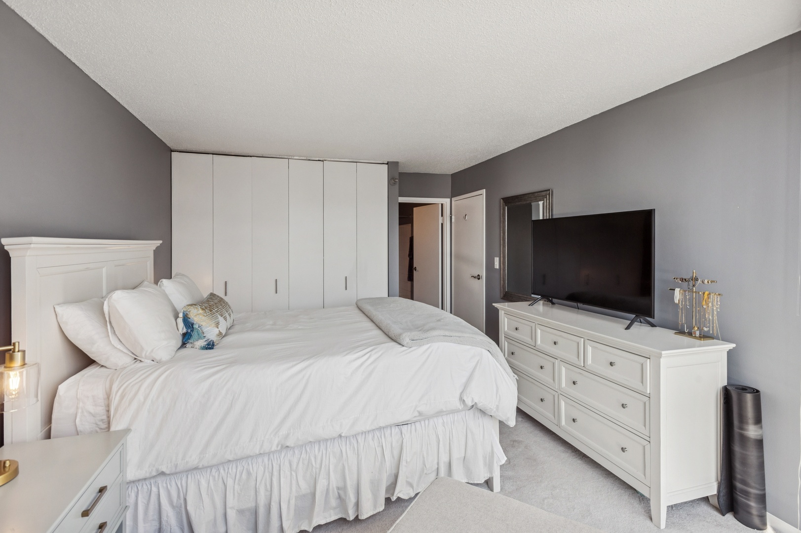 111 West Maple Street, Unit 1704 Chicago, IL 60610 - Photo 13 of 24 a bedroom with a bed and a flat screen tv