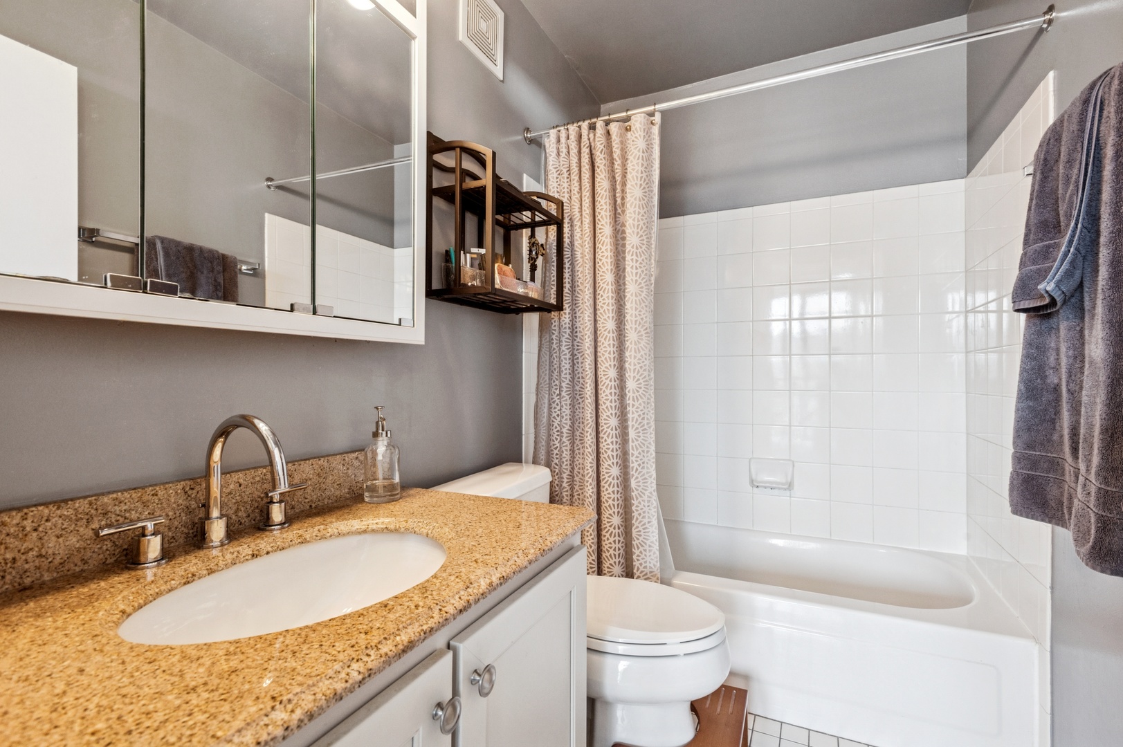 111 West Maple Street, Unit 1704 Chicago, IL 60610 - Photo 14 of 24 a bathroom with a granite countertop sink a toilet and shower