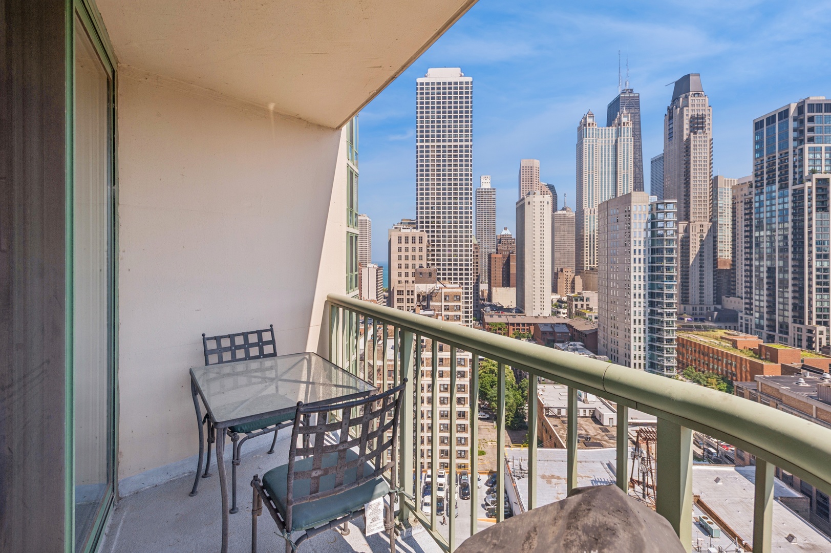 111 West Maple Street, Unit 1704 Chicago, IL 60610 - Photo 18 of 24 a view of a city from a balcony with furniture