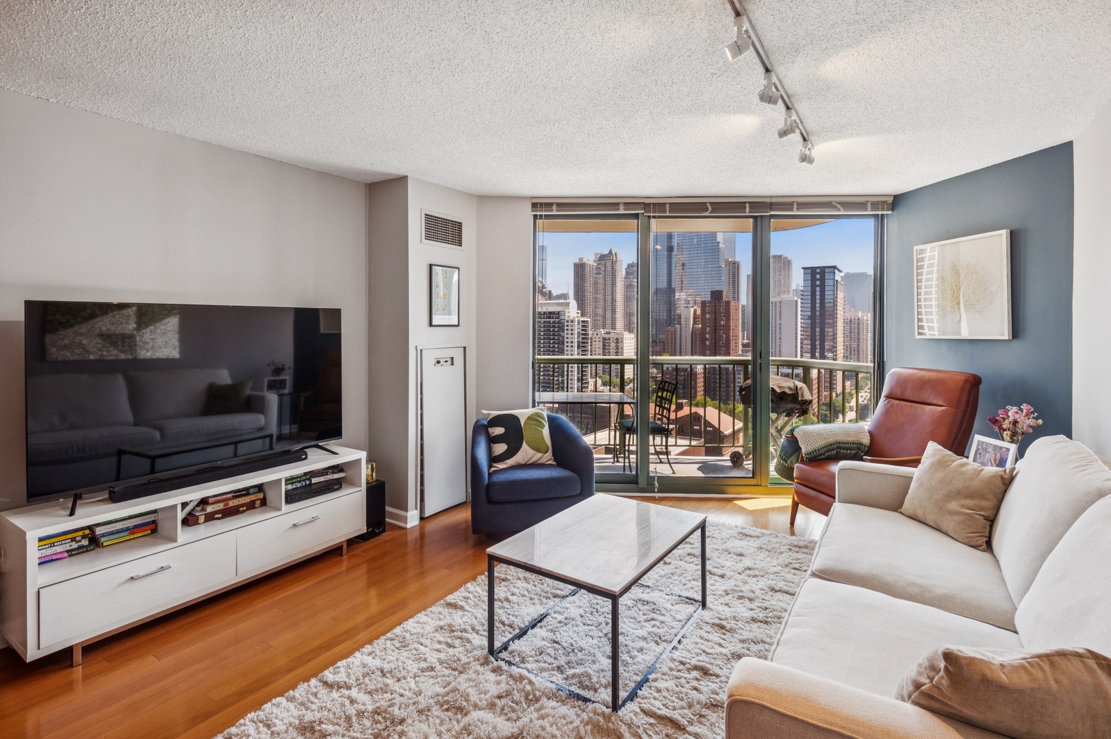 111 West Maple Street, Unit 1704 Chicago, IL 60610 - Photo 2 of 24 a living room with furniture and a flat screen tv