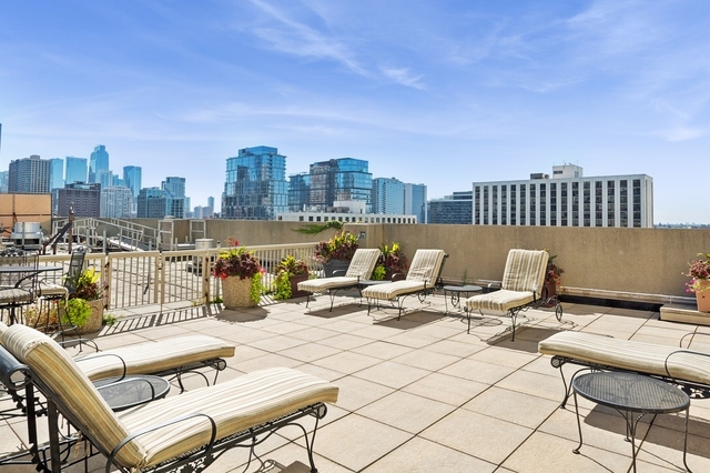 111 West Maple Street, Unit 1704 Chicago, IL 60610 - Photo 22 of 24 a view of a terrace with chairs and a table