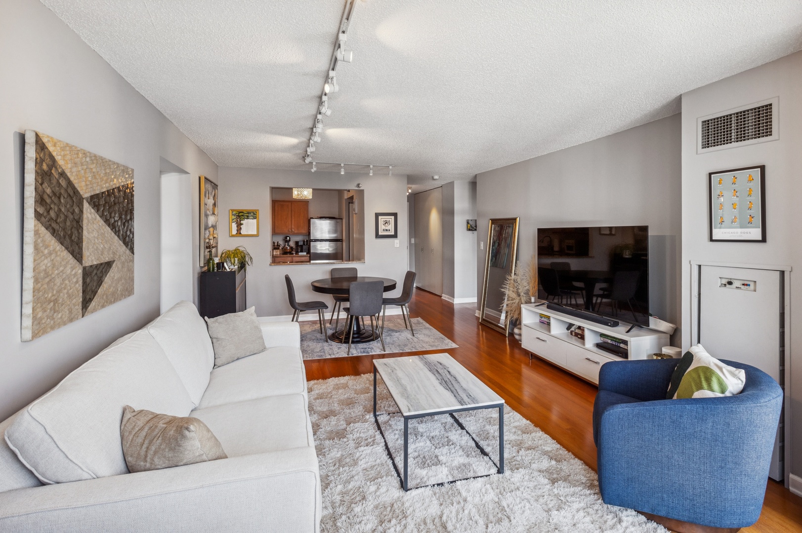 111 West Maple Street, Unit 1704 Chicago, IL 60610 - Photo 4 of 24 a living room with furniture and a flat screen tv