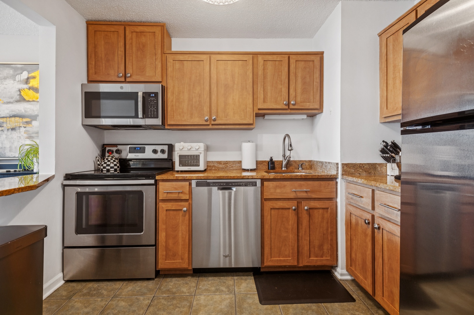 111 West Maple Street, Unit 1704 Chicago, IL 60610 - Photo 7 of 24 a kitchen with stainless steel appliances granite countertop a refrigerator stove and microwave